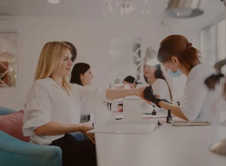 ELMAX beauty specialist providing a nail treatment